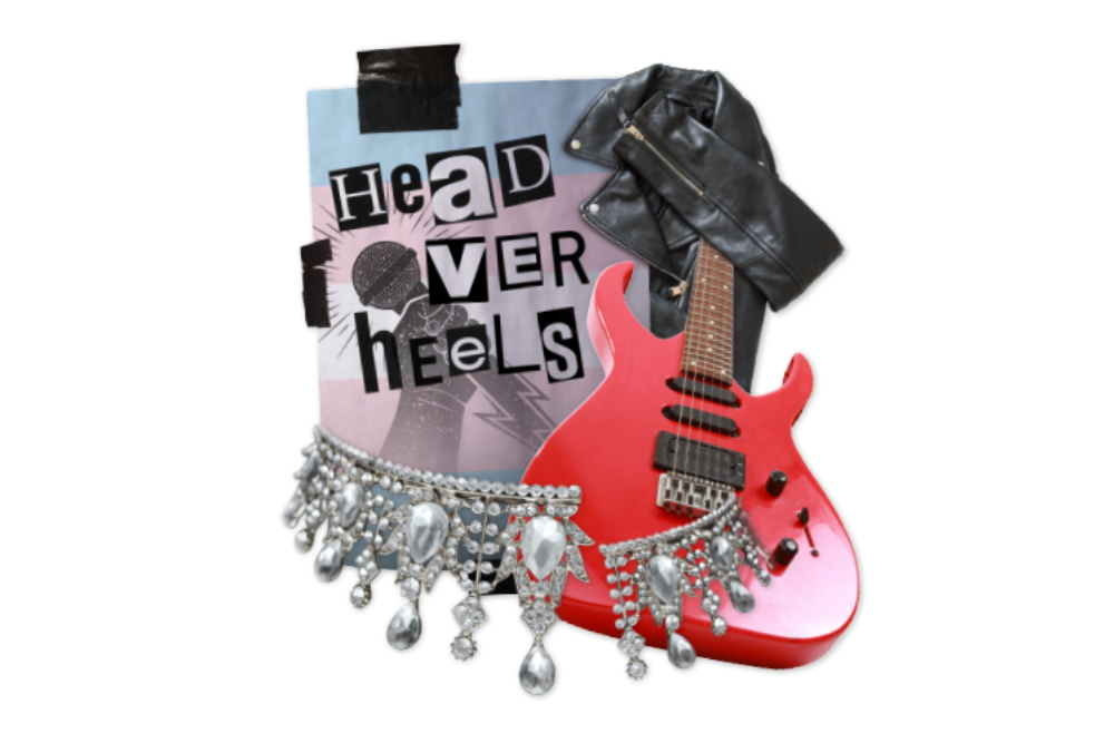 A red guitar with a black leather jacket hanging from the neck, wrapped with an upside down jeweled tiara and with a blue and pink sign in the background that says Head Over Heels