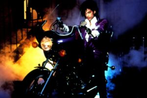 The singer, Prince, sitting on a large motorcycle.