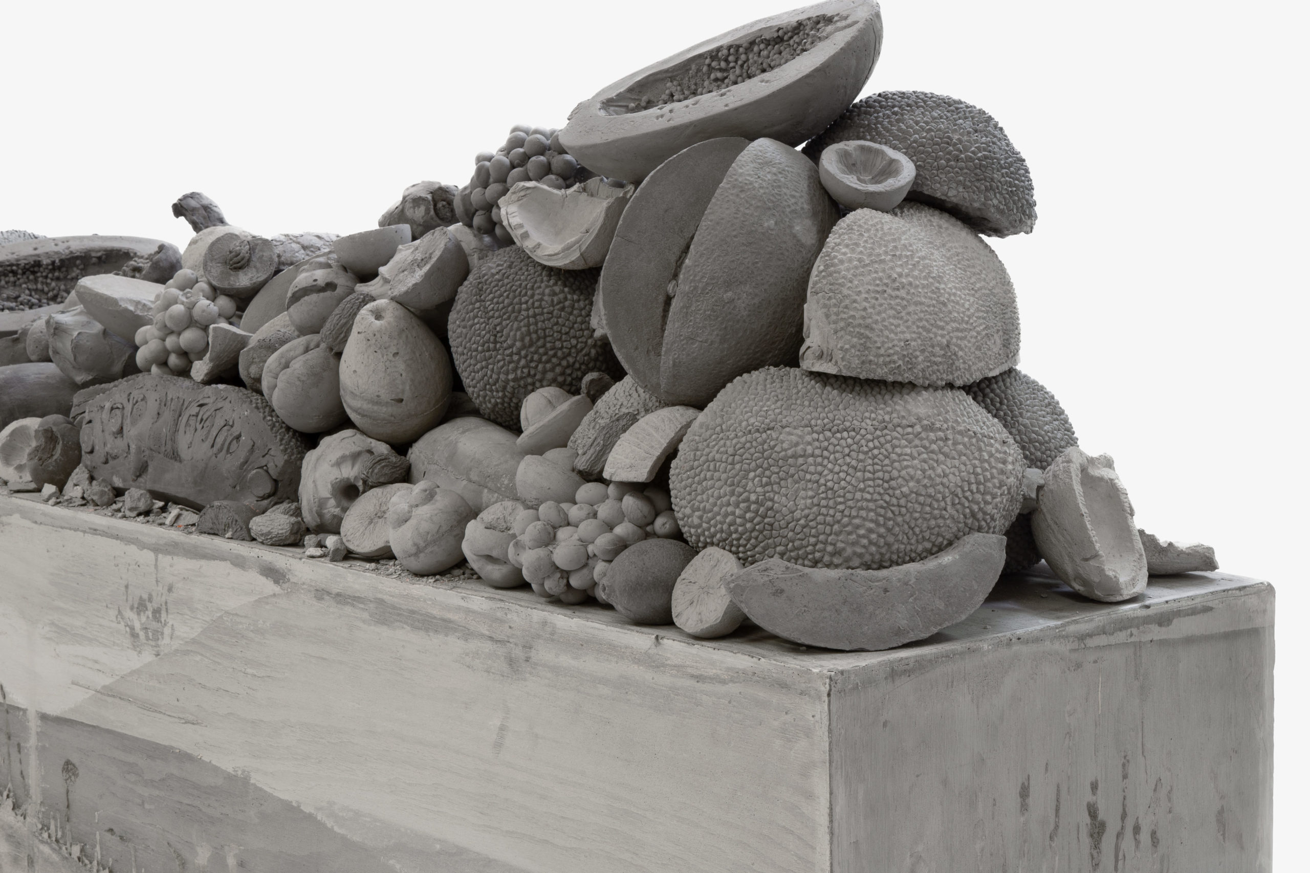 An installation of a pile of fruit made of clay.