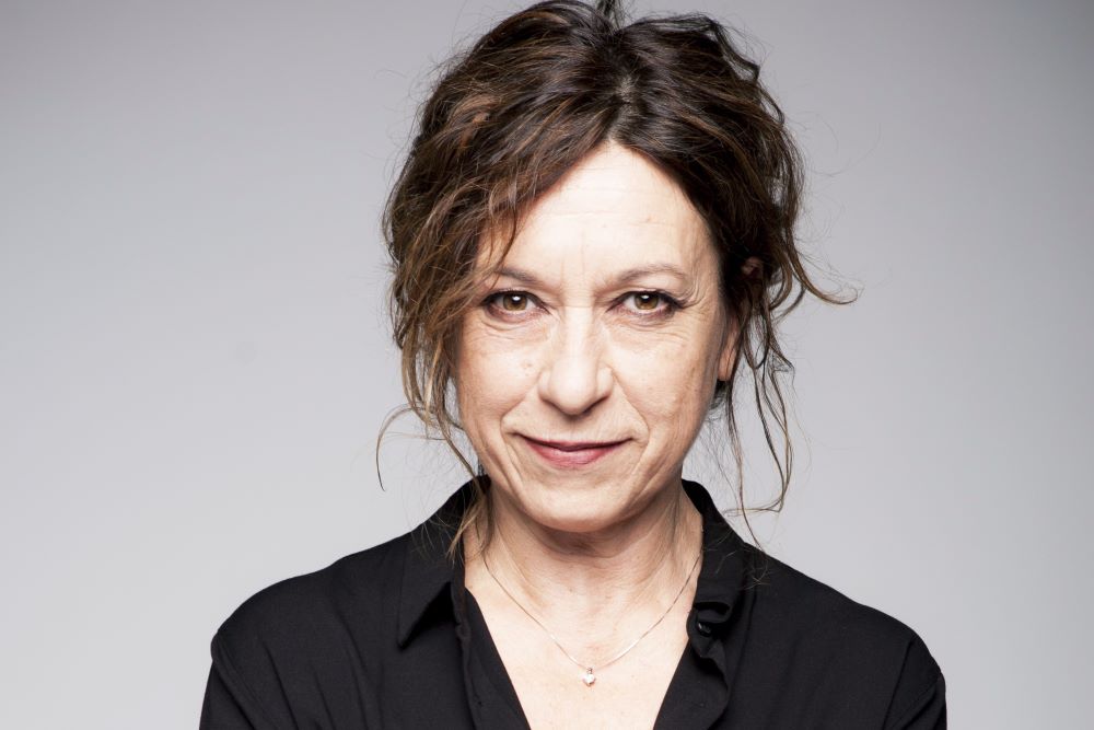 Portrait of women with hair pulled back and wearing a black shirt. Photo credit: Elena Bazzolo